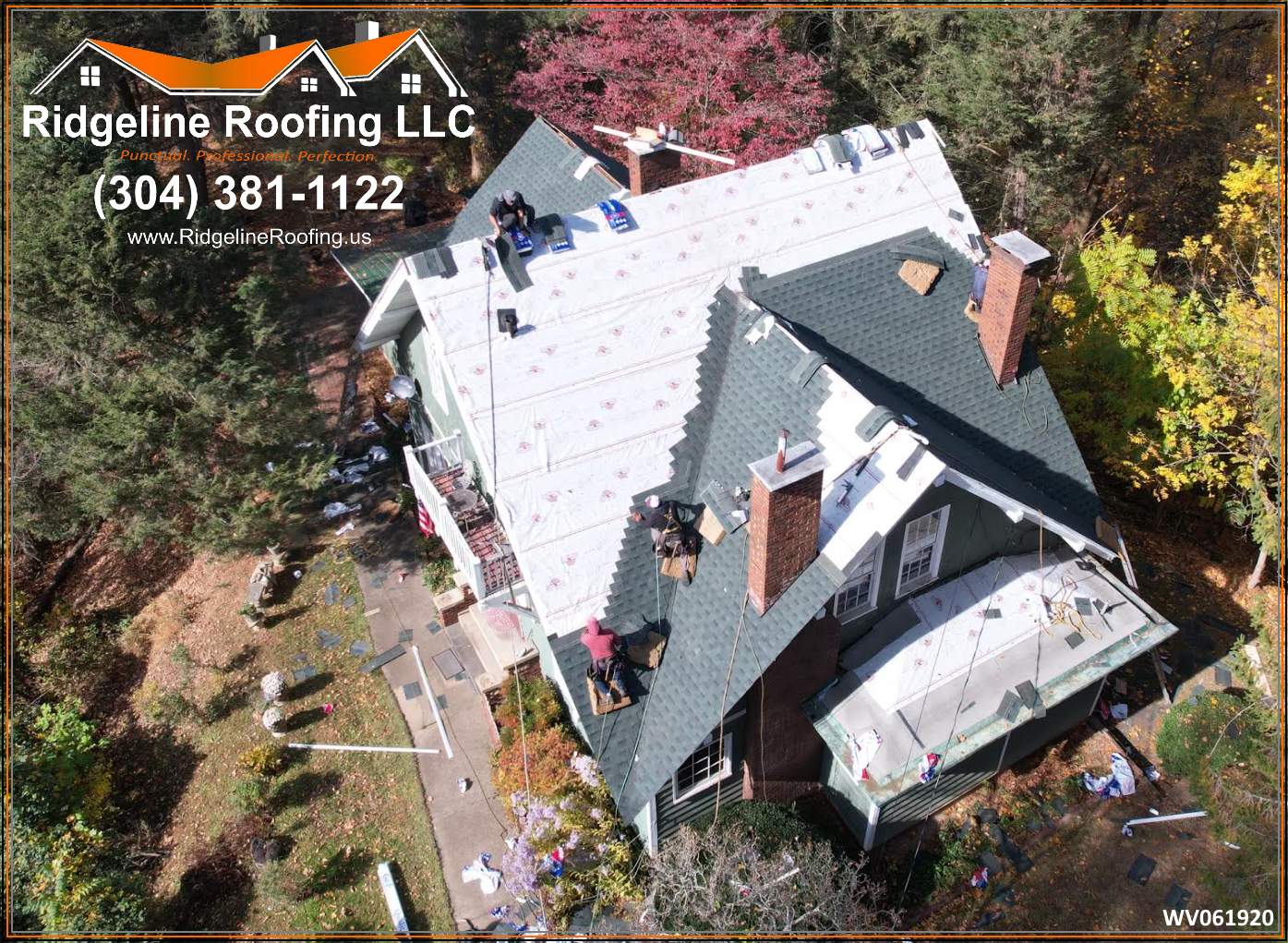 Aerial view of crew installing green shingles on a complex roof